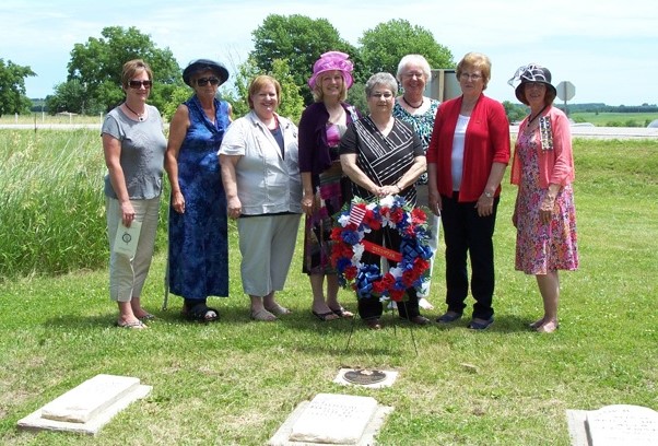 members at the grave marking